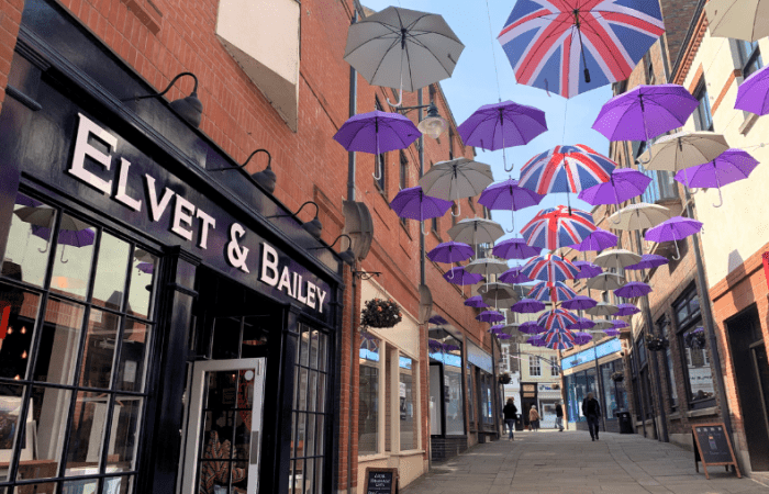 Umbrella Street at Prince Bishops Place with Elvet and Bailey shopfront in foreground